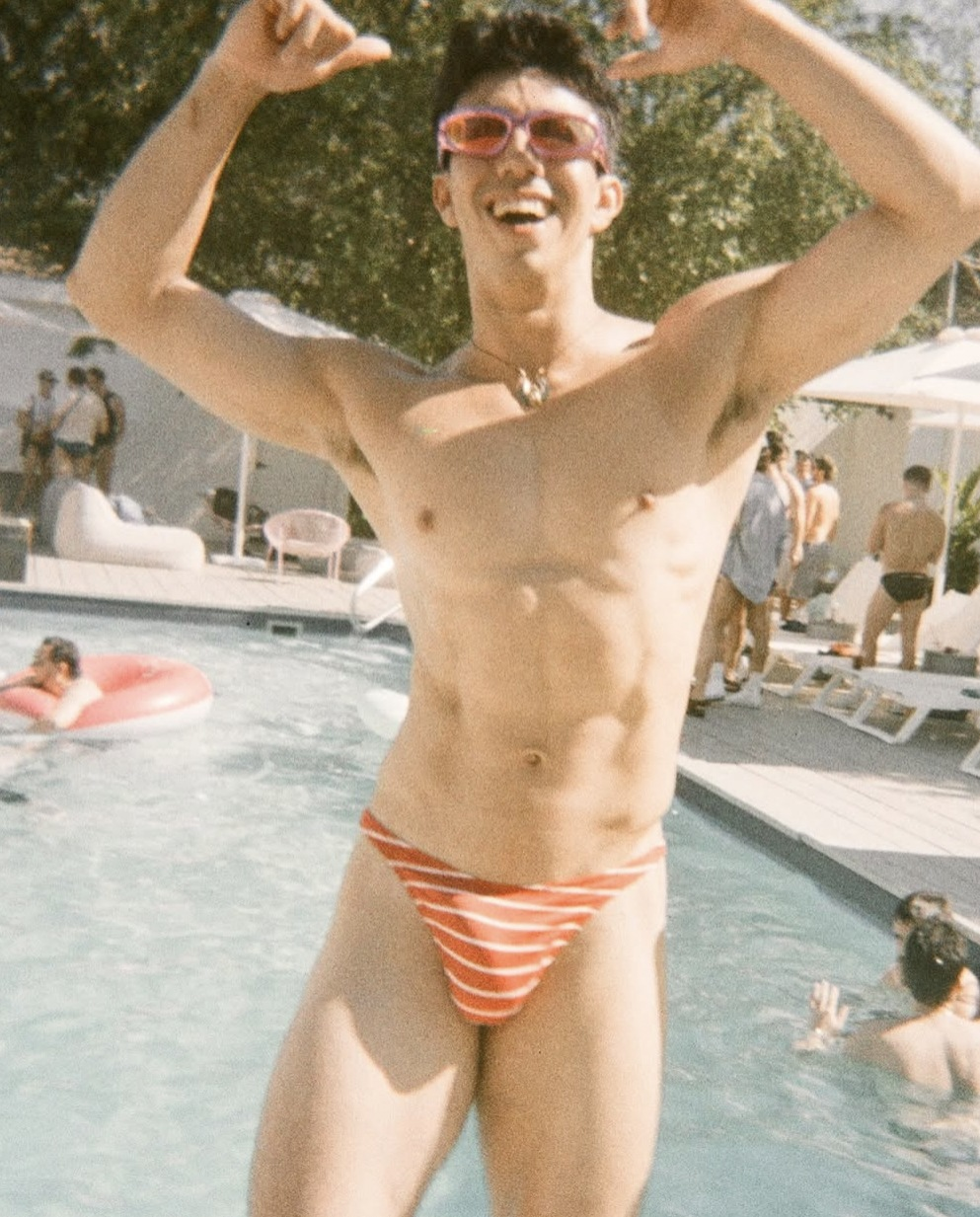 Guests partying at a sunny pool